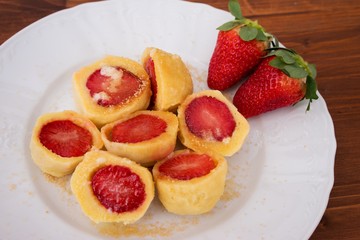 Czech traditional seasonal meal strawberry dumplings with hot dissolved butter and brown cane sugar typical example of the sweet homemade traditional main dish in czech republic dedicated for children