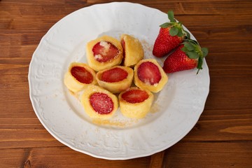 Czech traditional seasonal meal strawberry dumplings with hot dissolved butter and brown cane sugar typical example of the sweet homemade traditional main dish in czech republic dedicated for children