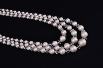 White pearls luxury necklace on black background