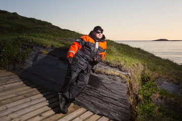 fisherman on the beach. Worker in port
 Evening. Dirty clothes.