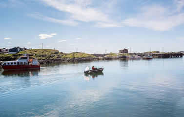 Two men in a motor boat sailing along the bay. Sea fishing. Norway