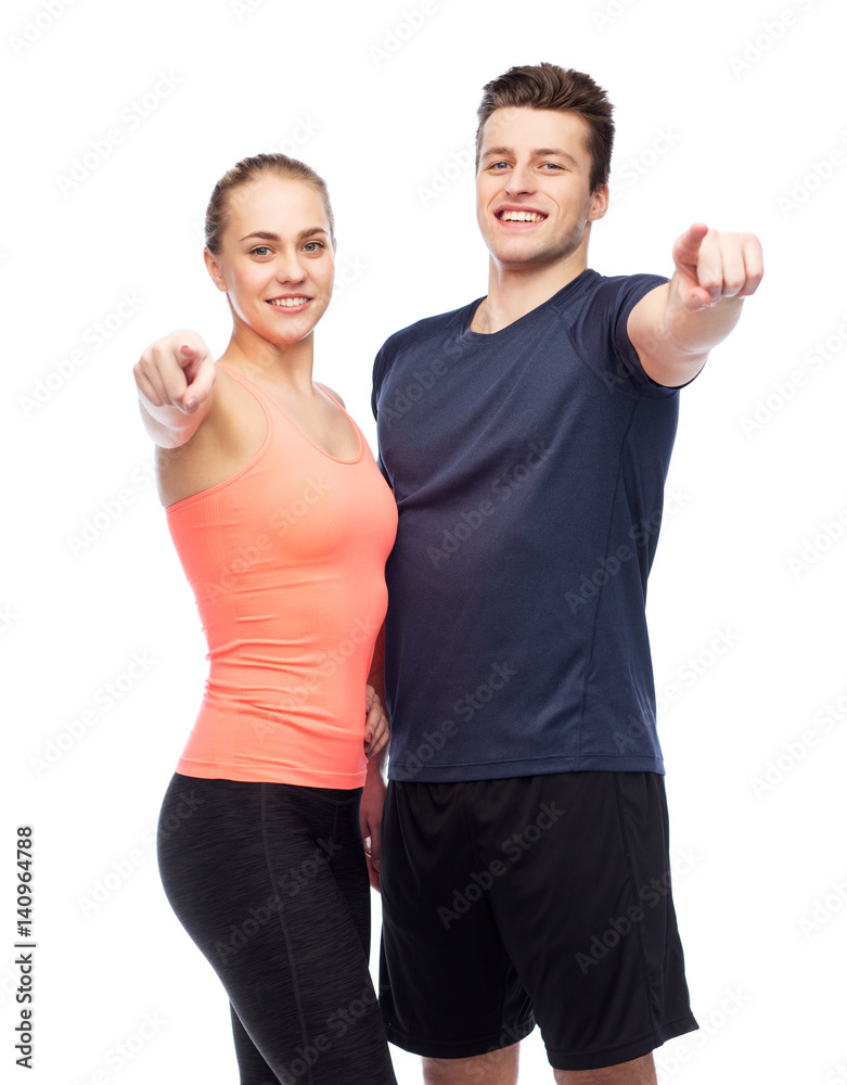 Canvas Prints happy sportive man and woman pointing finger