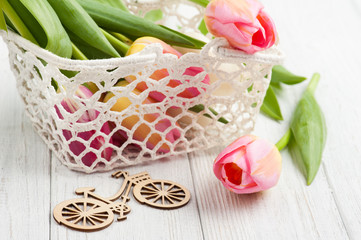 Fototapeta na wymiar Bouquet of pink tulips in crochet basket