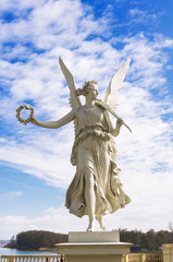 Statue of the goddes Nike, blue sky and clouds