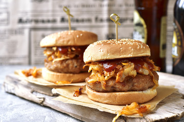 Burger with meat cutlet and fried cabbage.