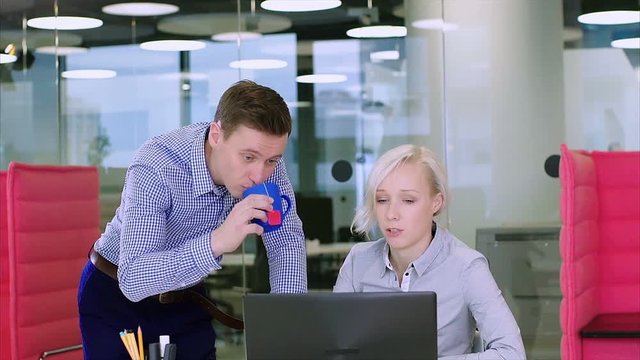 Positive office workers unsuccessfully joking with a female coworker
