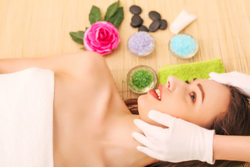 Obraz na płótnie Canvas Close-up of a young woman getting spa treatment at beauty salon. spa face massage. facial beauty treatment. spa salon.