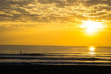 Man Paddle Surfing at Sunrise