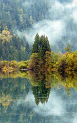 Azure lake in the mist. Jiuzhaigou Valley was recognize by UNESCO as a World Heritage Site and a World Biosphere Reserve - China - 140968543