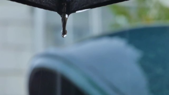 Rain drips and splashes of scatters in the telephone booth close up shot