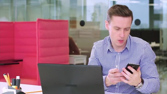 Busy multitasking attractive businessman in the office