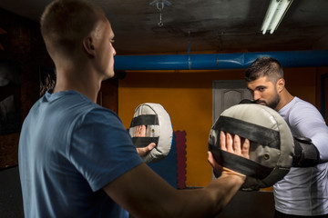 Muscular Boxer Having a Sparring Session with his Trainer