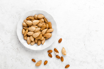 Almond nuts on white background directly above copy space flat lay