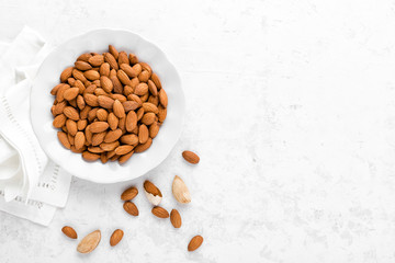 Almond nuts on white background directly above copy space flat lay