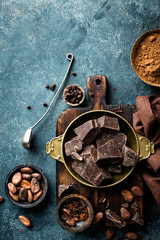 Fototapeta na wymiar Dark chocolate pieces crushed and cocoa beans, culinary background, top view