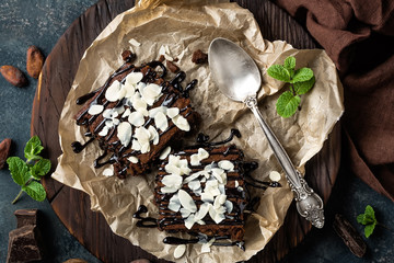 Chocolate brownie cake, dessert with nuts on dark background, directly above, flat lay