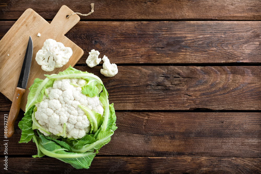 Wall mural Fresh whole cauliflower on wooden rustic background, top view - Wall murals
