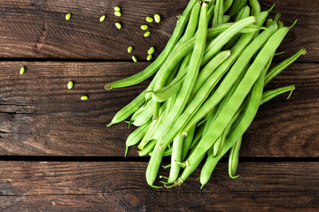 Fresh green beans on dark wooden rustic background top view copy space flat lay