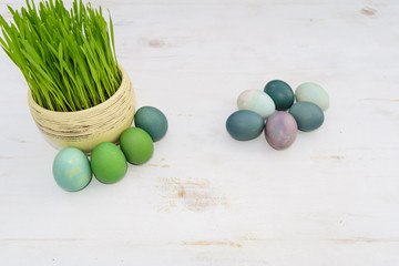 Easter eggs in basket with green grass, isolated on white