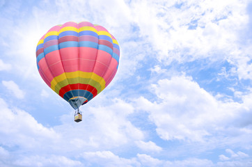 Colorful balloon over bright sky.