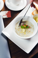 Closeup on a young woman's hands as she is having breakfast in cafe
