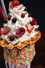 Unique giant milkshake with waffle, ice cream and berry on top