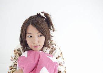 Young woman holding cushion