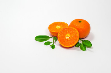 Two oranges are placed on a white background.And half cut to see a meat
