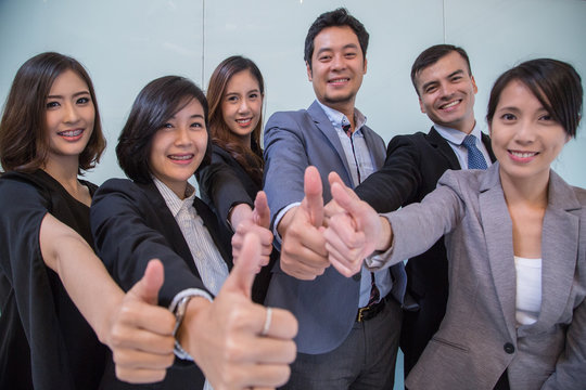 Thumbs up business people