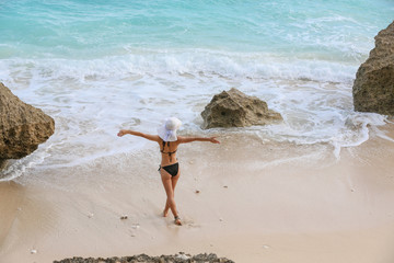 Fototapeta na wymiar Young woman enjoying time at the beach 