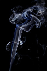 Abstract art. Color white blue smoke from the aromatic sticks on a black background. Background for Halloween. Texture fog. Design element. The concept of aromatherapy.