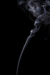 Abstract art. Color white blue smoke from the aromatic sticks on a black background. Background for Halloween. Texture fog. Design element. The concept of aromatherapy.