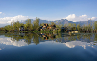 Fototapeta premium Small rural village next to still river