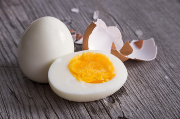 Sliced hard boiled eggs on wooden cutting board