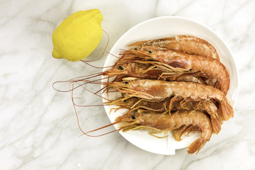 Raw shrimps and lemon with copyspace