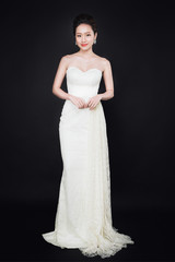 Fototapeta premium Asian woman with fashion makeup in luxury black dress while confetti falling on her.