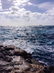 Big waves breaking on the shore with sea foam