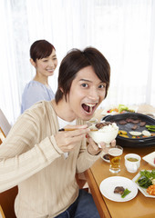 Husband and wife eating Japanese barbeque