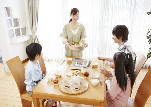 Parents and kids sitting around Japanese hot pot