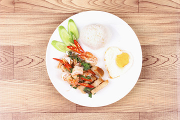 Jasmine rice topped stir - fried spicy basil with meat.