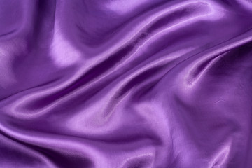 Silk background, texture of violet shiny fabric