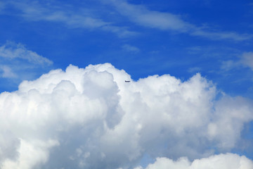Fototapeta na wymiar Cumulus clouds and aircraft