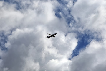 Fototapeta na wymiar Plane among the clouds