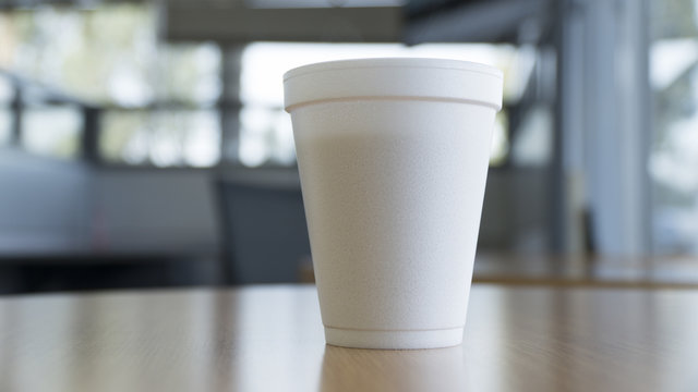 disposable coffee cup on table in a large bright room