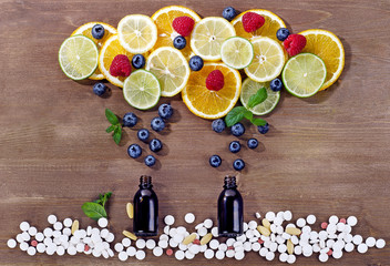 Slices of citrus fruits, berries and pills.  Healthy lifestyle concept.