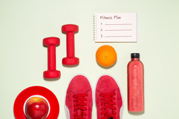 Healthy lifestyle concept. Sneakers, tea, apple and headphone on pastel color background.