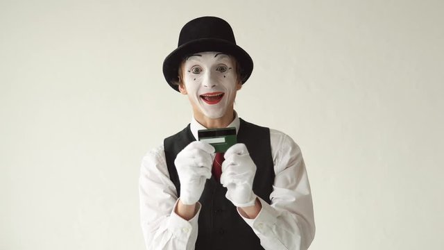 man MIM takes from his pocket a credit card. Manipulation of credit cards on white background