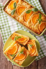 Obraz na płótnie Canvas Traditional Greek Orange Pie With Phyllo - Portokalopita close-up. Vertical top view