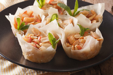 Filo pastry stuffed with apples and peanuts closeup. horizontal