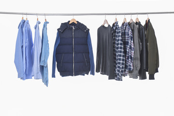 Set shirts ,clothing on hangers on a white background
